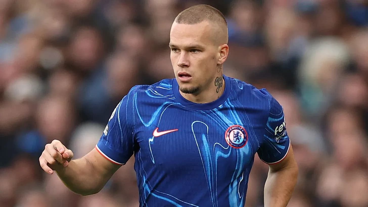 Player in blue Chelsea jersey running on pitch
