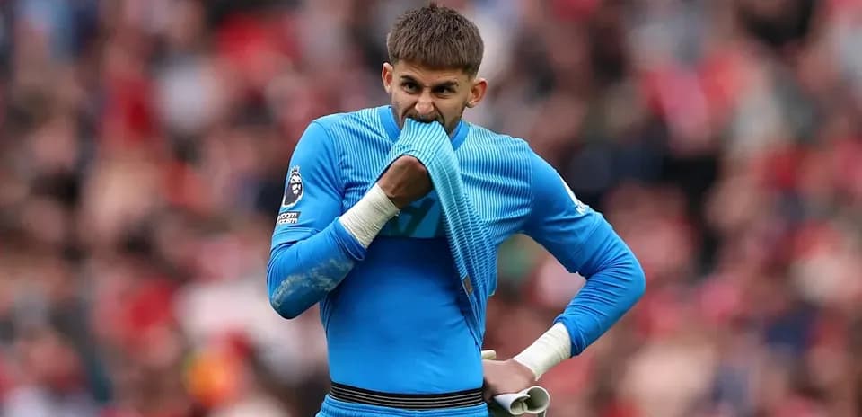 Goalkeeper biting his jersey during match