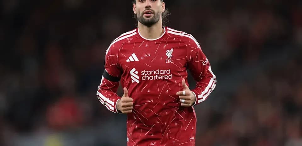 Player in Liverpool kit giving thumbs up