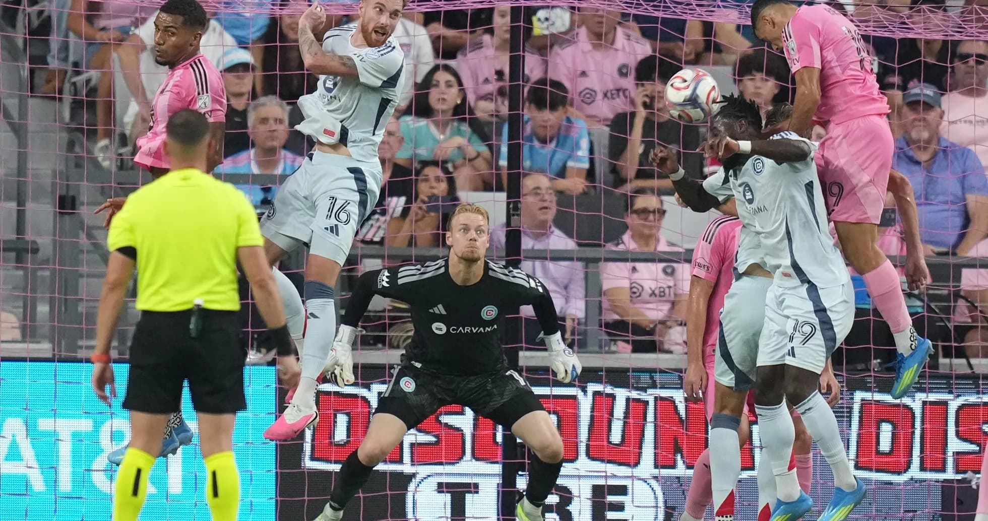 Players contesting a header during MLS match