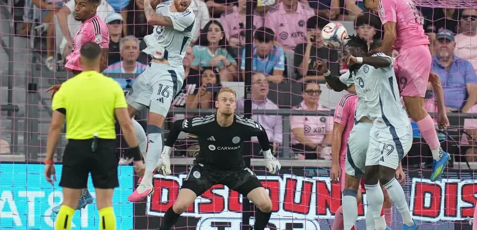Players contesting a header during MLS match