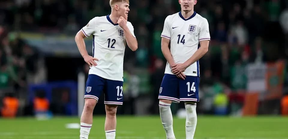 Two England players discussing on the pitch