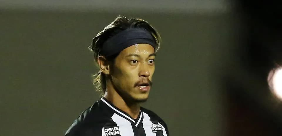 Player in black and white jersey on field