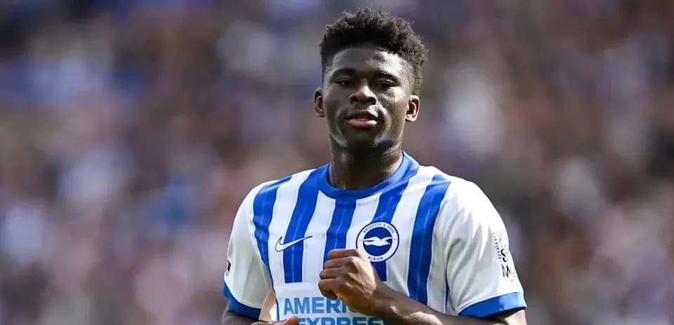 Player celebrating in Brighton home kit on field