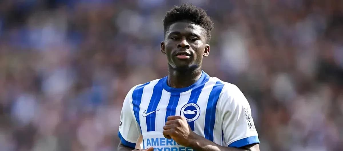 Player celebrating in Brighton home kit on field