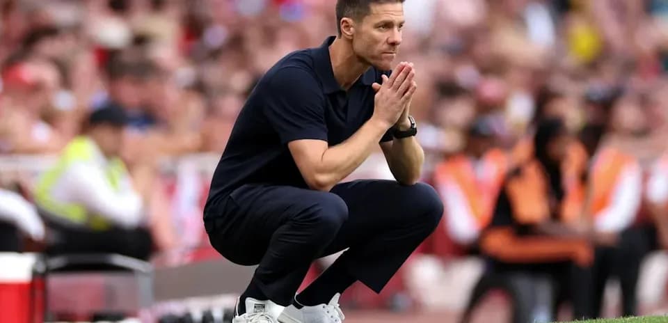 Coach kneeling on sidelines during a match