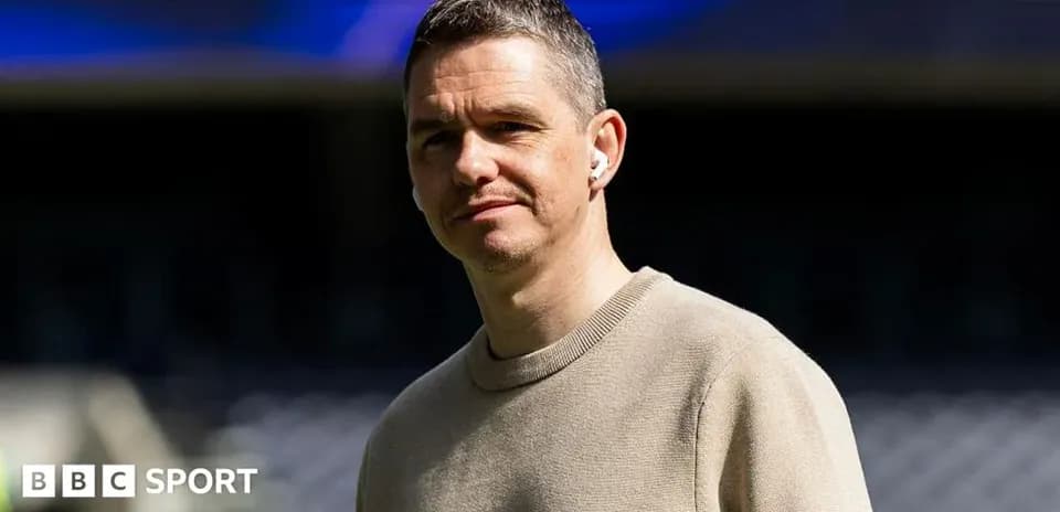 Person wearing earbuds at a sports venue