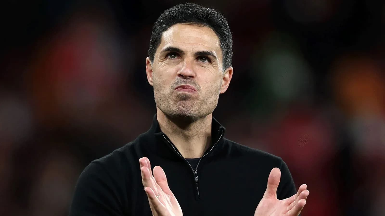 Coach applauding during post-match celebration