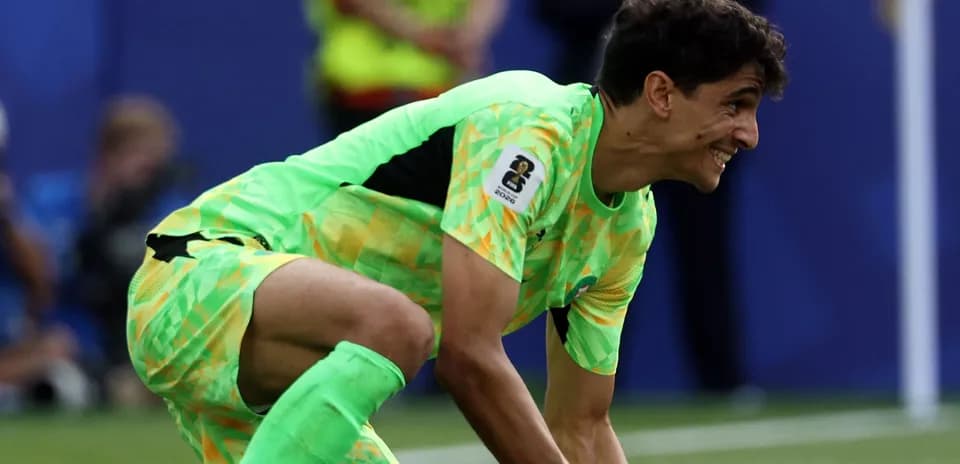 Goalkeeper in green kit preparing to play