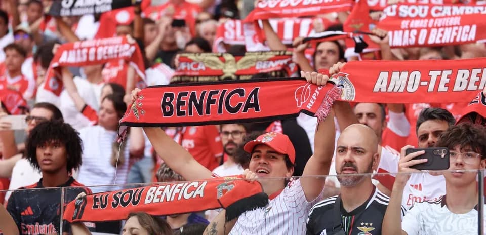 Benfica fans cheering with scarves during match