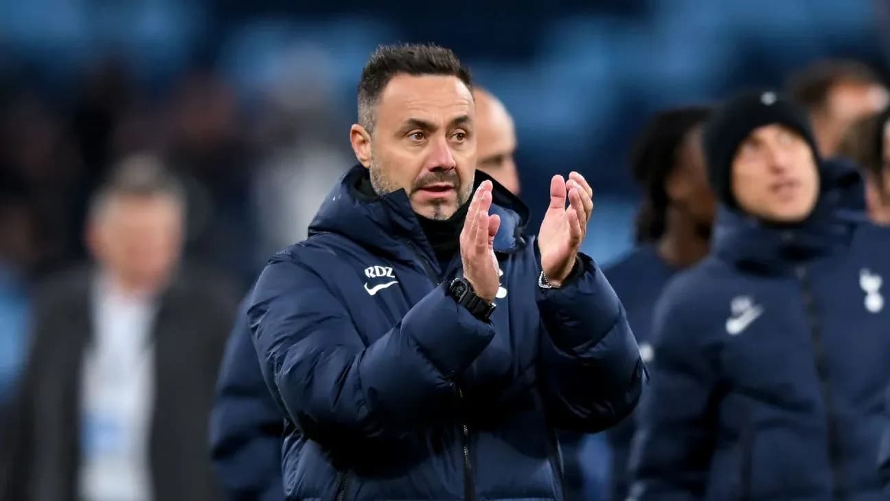 Coach applauding players after the match