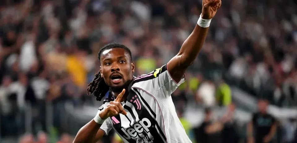 Player celebrating goal with finger raised at stadium