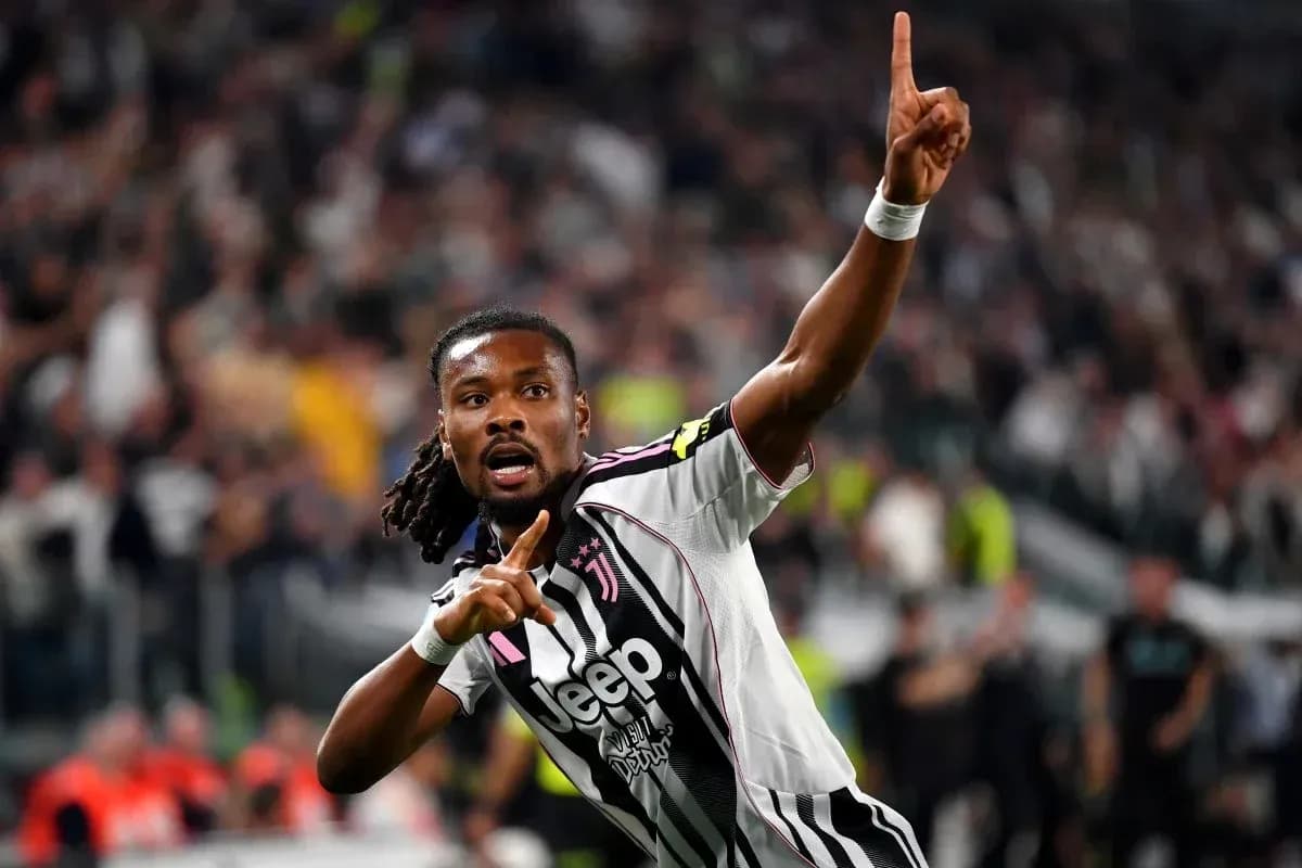 Player celebrating goal with finger raised at stadium