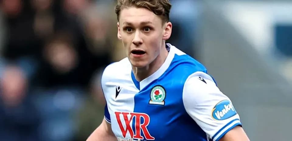 Player running on the pitch in Blackburn Rovers kit