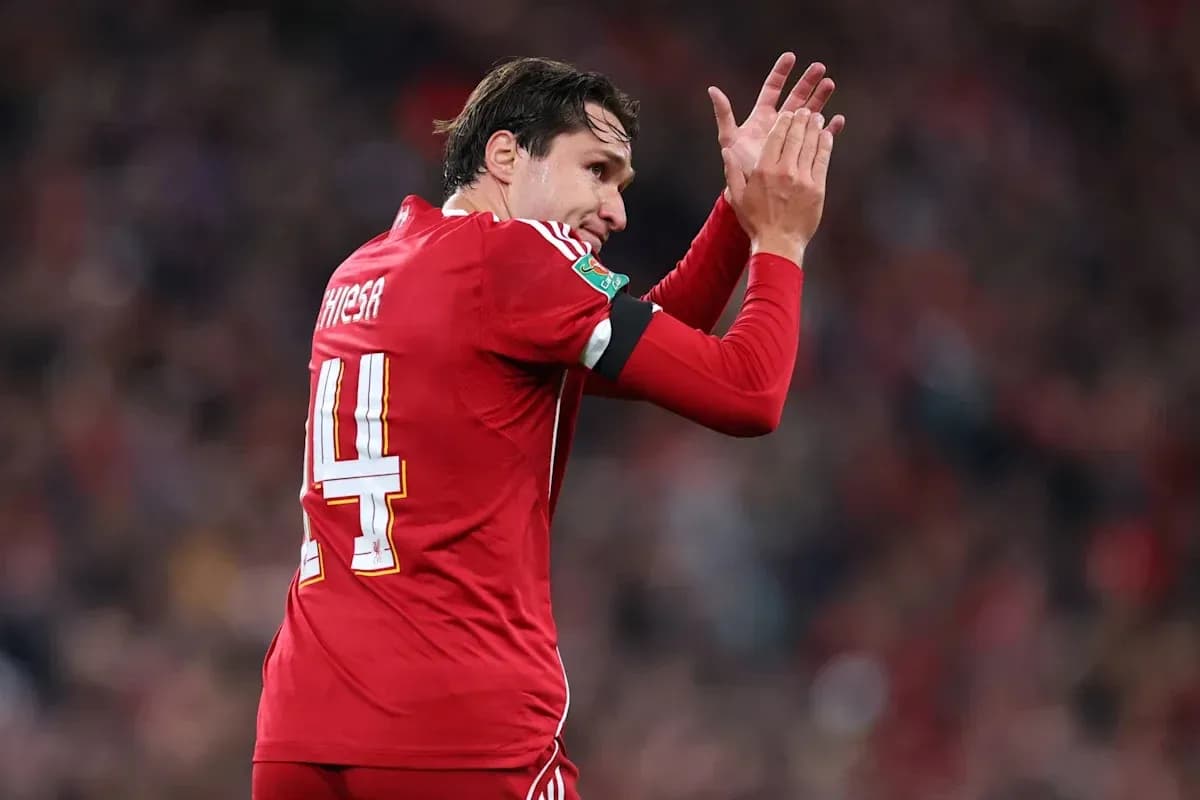 Player wearing red jersey applauding fans