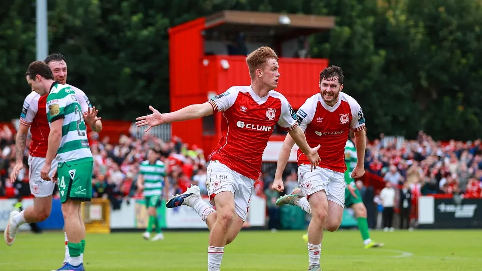 Player celebrating a goal with teammates during match