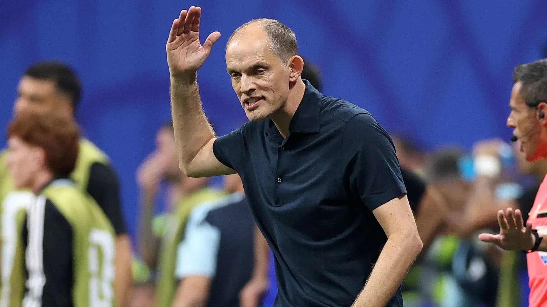 Coach gesturing during a match on the sidelines