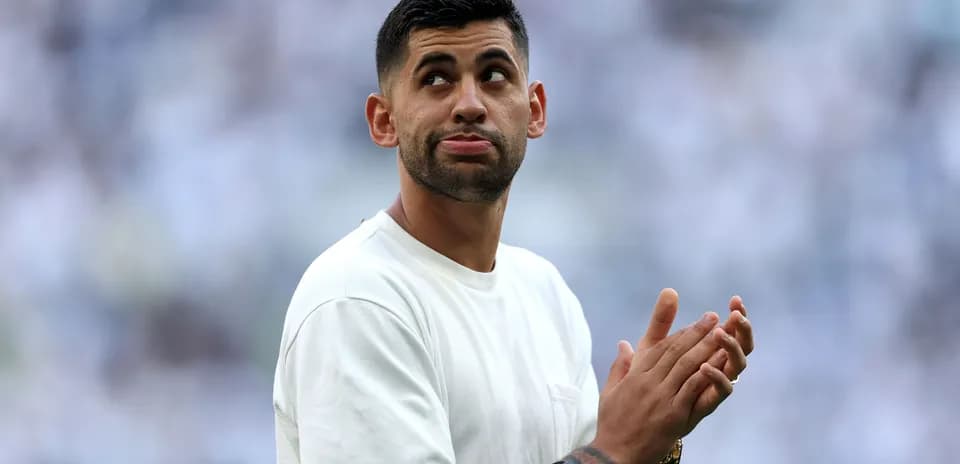 Player clapping in a stadium with fans