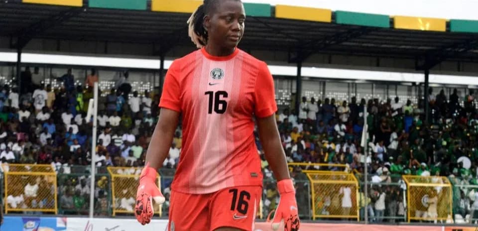 Goalkeeper in red uniform walking on field