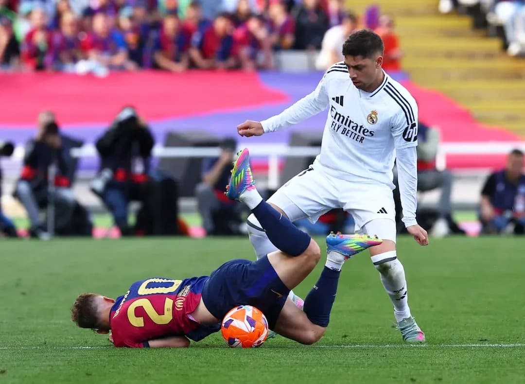 Barcelona player tackled during El Clásico match