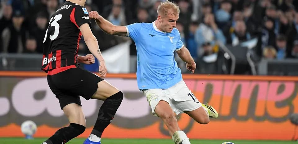 Lazio player dribbling against AC Milan defender