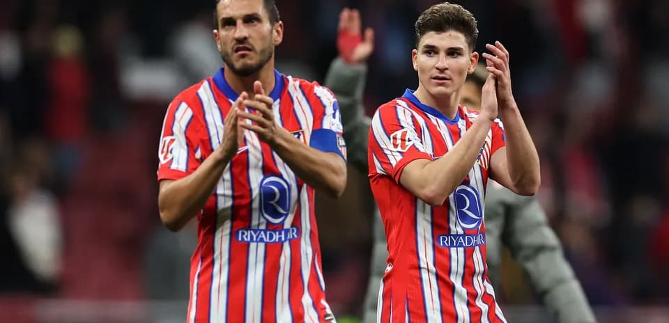 Two players applauding fans after a match