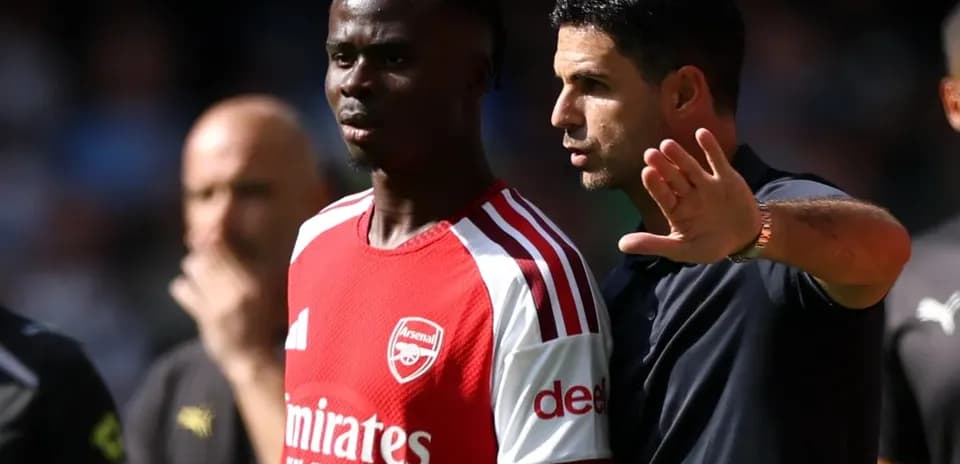 Manager discussing strategy with player on field