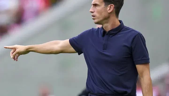 Coach gesturing from the sidelines during match