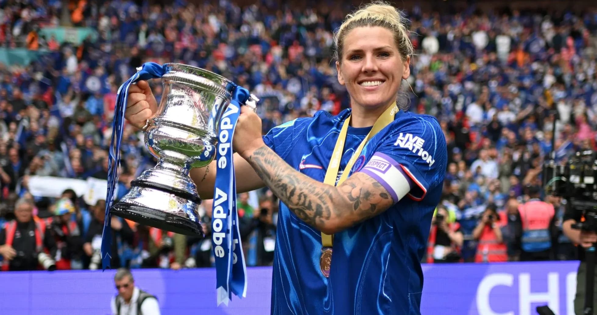 Player celebrating with trophy in front of fans