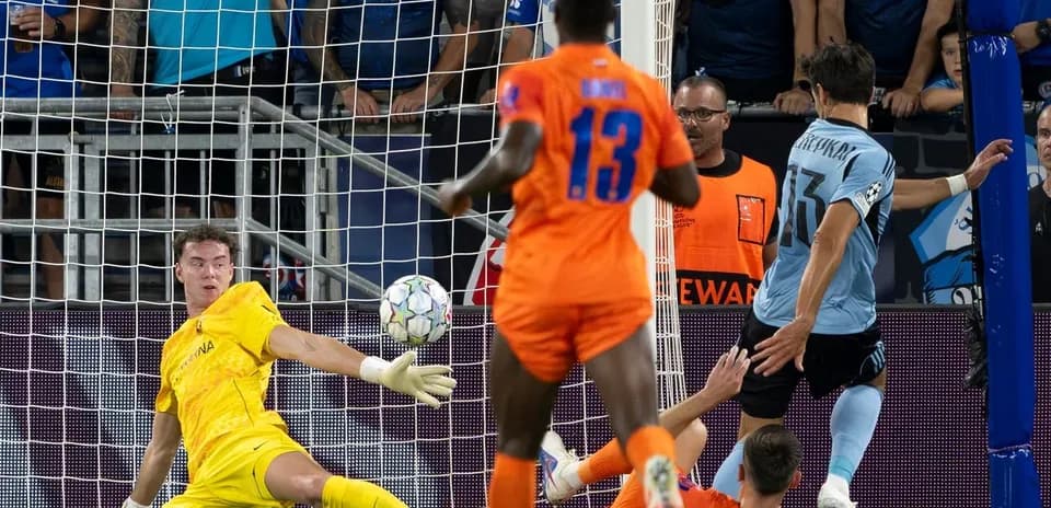 Goalkeeper making a save during UEFA match