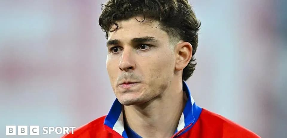 Player in red jersey during match preparation