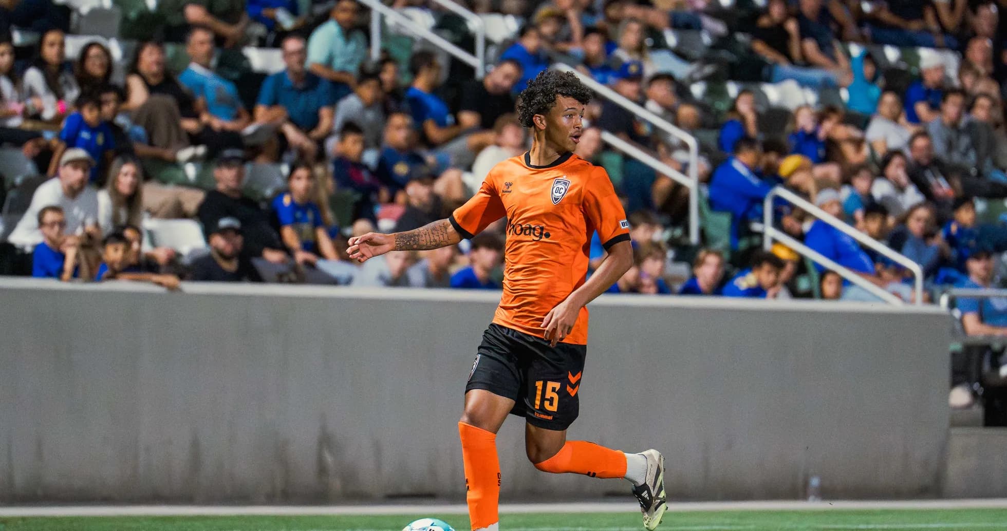 Player in orange jersey during USL match