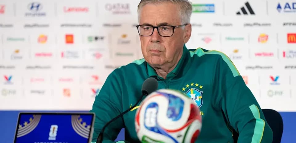 Manager at press conference with soccer ball
