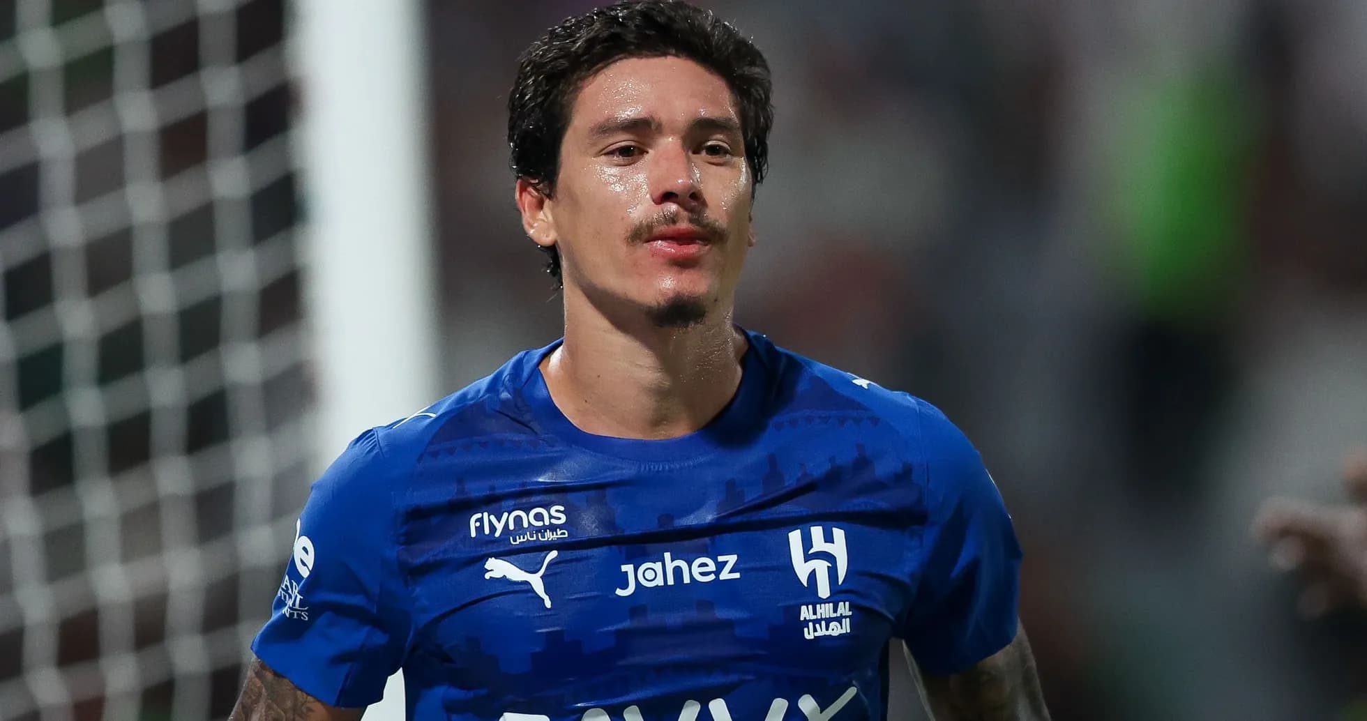Player in blue jersey celebrating on the field