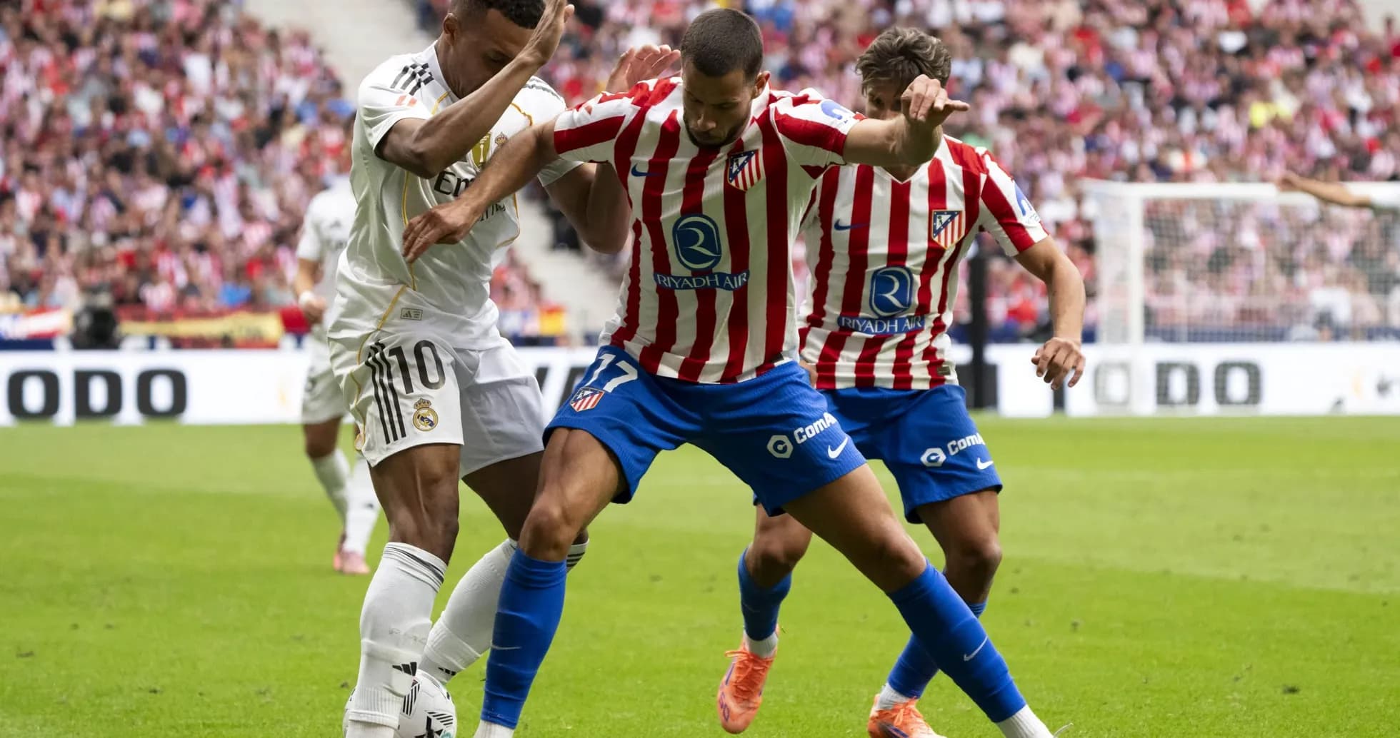Real Madrid and Atletico Madrid players contesting the ball