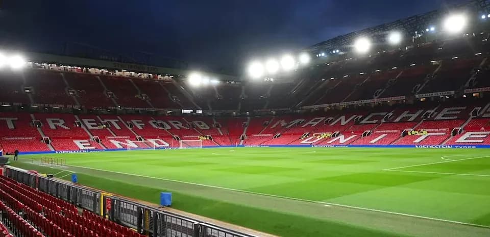 Old Trafford stadium with empty stands and pitch