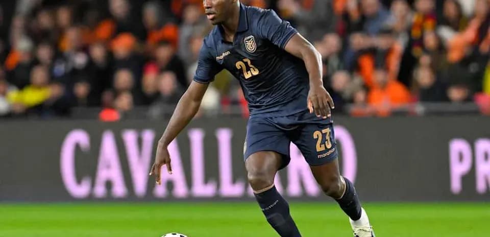 Player in blue kit dribbling a soccer ball