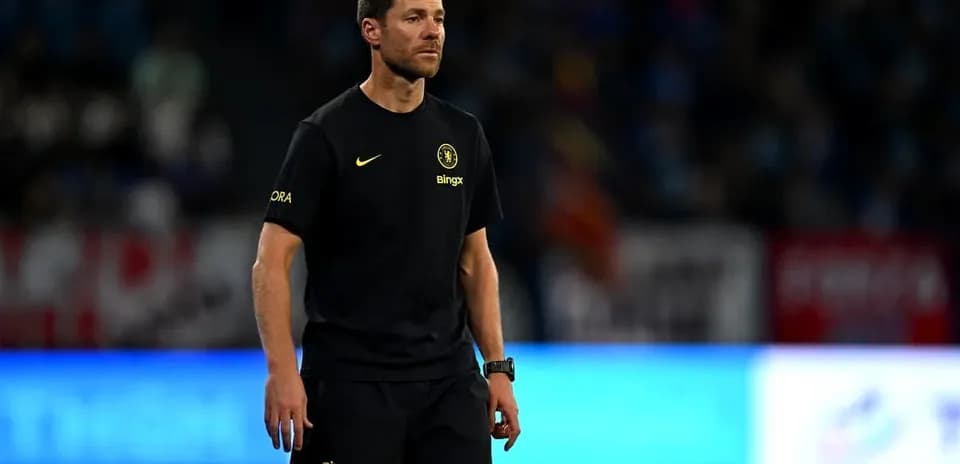Coach walking on the pitch during a match