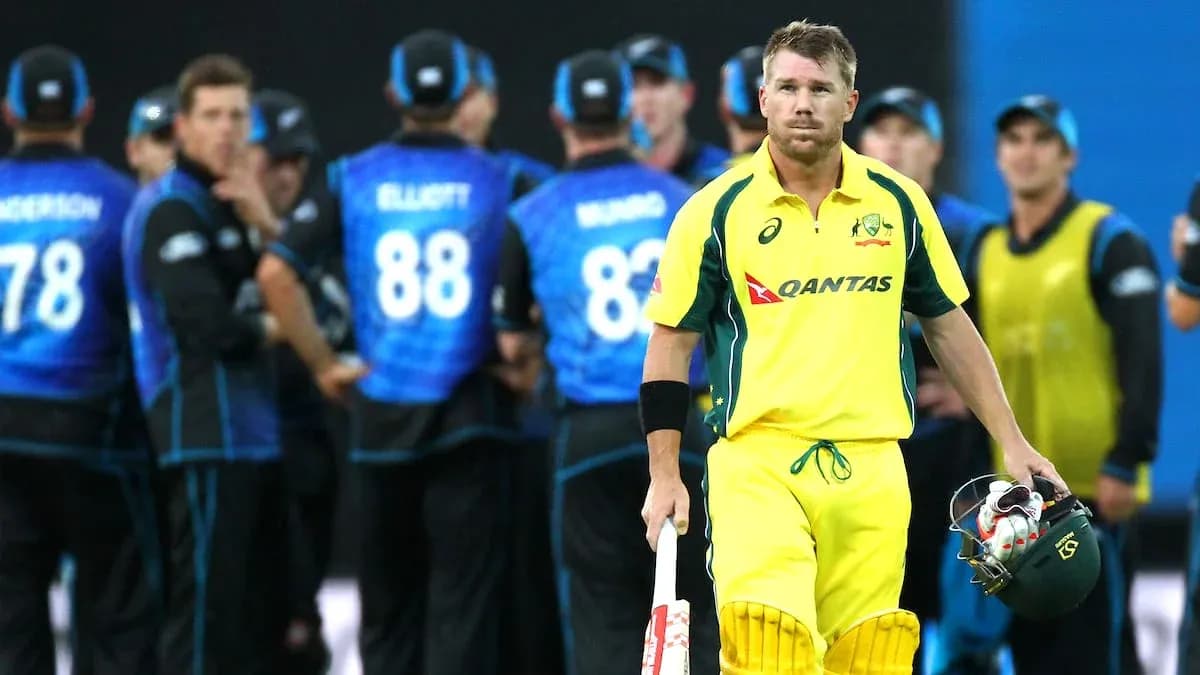 Australian player walking past New Zealand team celebration