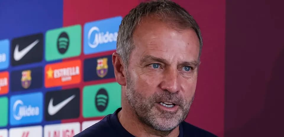 Manager speaking at press conference with club logos behind