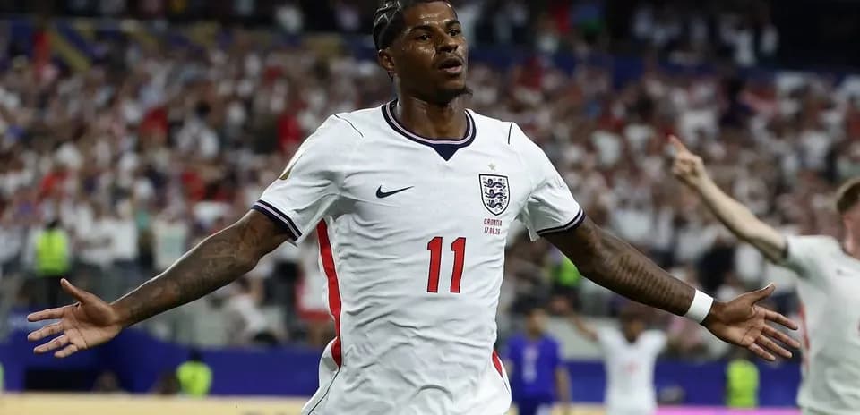 Player celebrating goal with arms outstretched