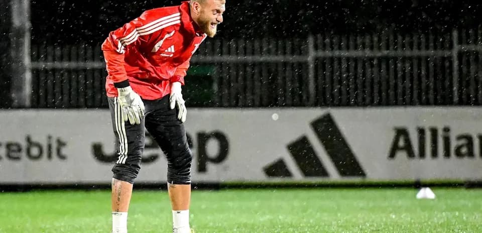 Goalkeeper training in the rain on pitch