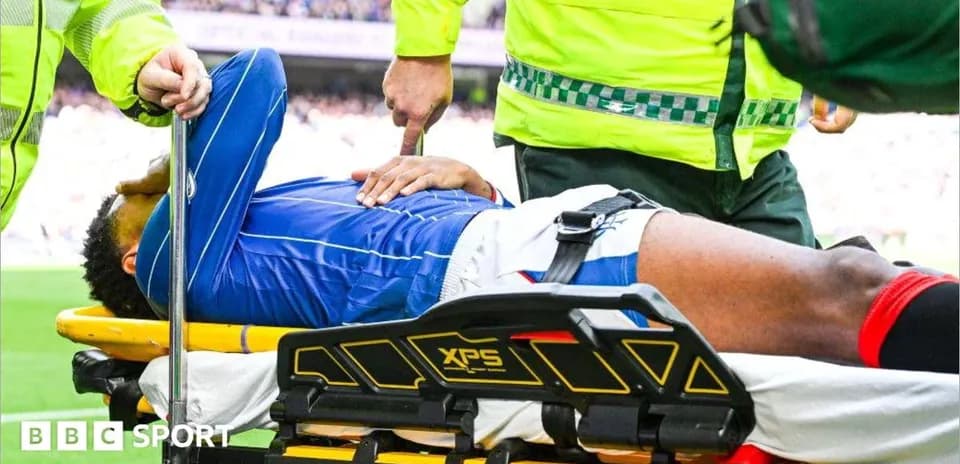 Player on stretcher receiving medical attention