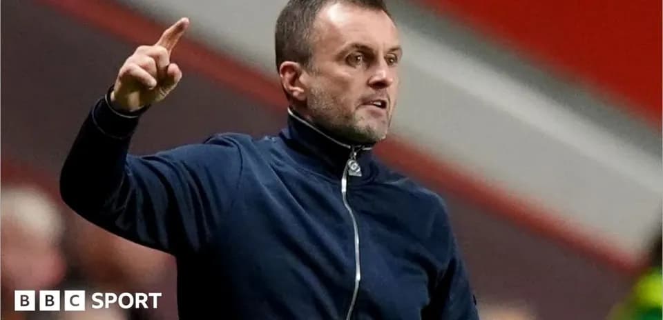 Coach gesturing during a match on the sidelines
