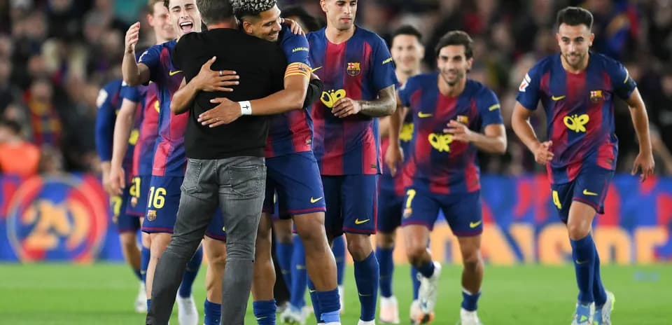 Barcelona players celebrating with their coach after match
