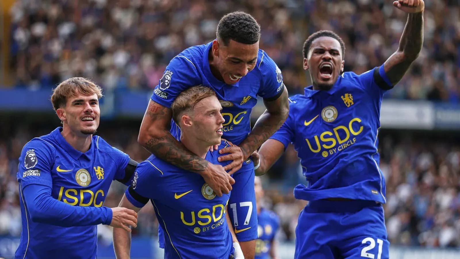 Chelsea players celebrating a goal on the pitch