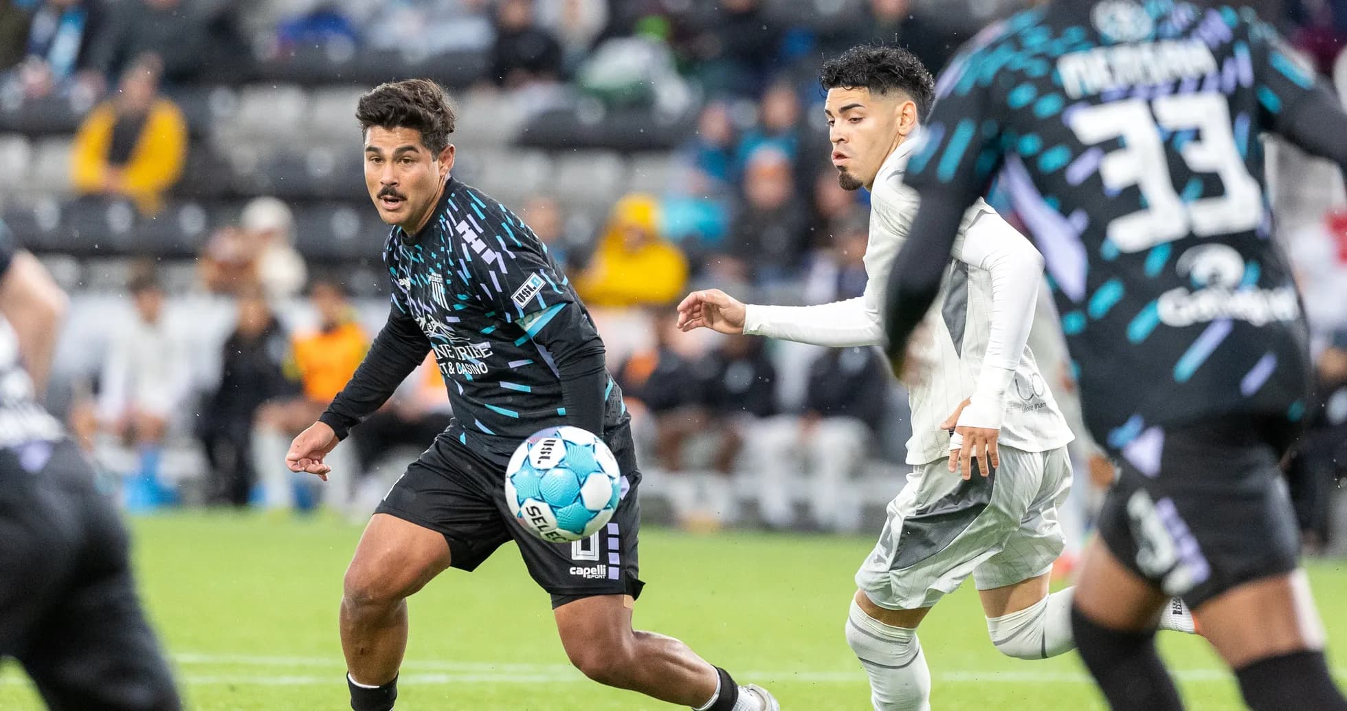 Player dribbling the ball during Velocity match