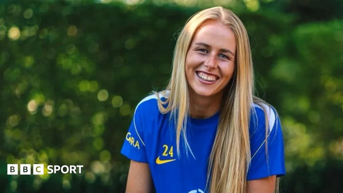 Female player smiling in blue team jersey