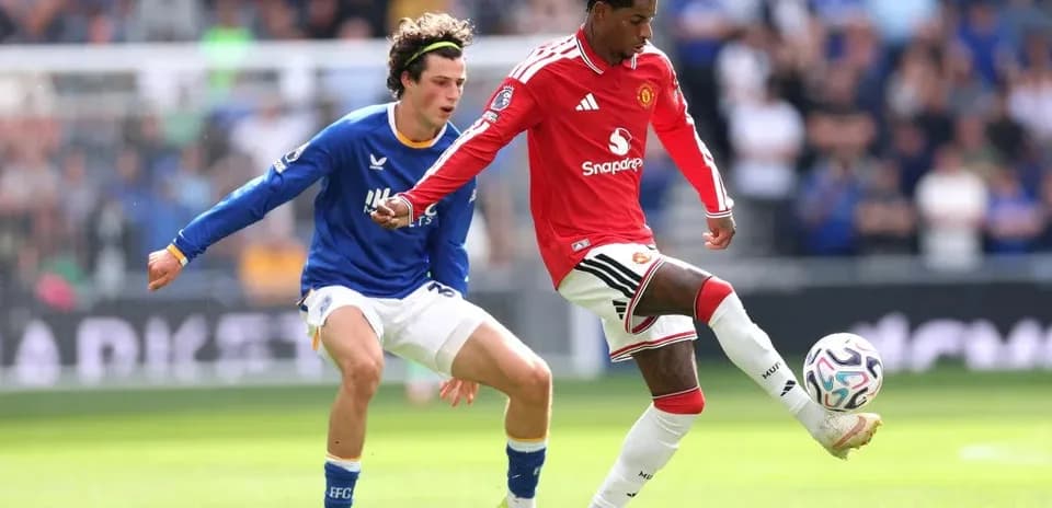 Player dribbling ball while being challenged by opponent
