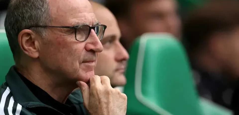 Coach sitting on bench during match